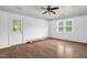 Bedroom with wood-look flooring, ceiling fan, white trim, and a window at 5805 Craig Rd, Durham, NC 27712