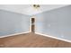 Bedroom featuring hardwood floors, neutral paint, a ceiling fan, and access to the kitchen at 5805 Craig Rd, Durham, NC 27712