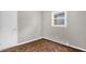 Bedroom features tile floor, white door, and a window at 5805 Craig Rd, Durham, NC 27712