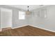 A dining room featuring wood-look floors, a hanging light fixture, and neutral-colored walls at 5805 Craig Rd, Durham, NC 27712