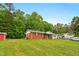 Charming one-story brick home featuring a well-maintained lawn and a shed in a quiet neighborhood at 5805 Craig Rd, Durham, NC 27712