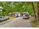 Cozy single-Gathering home with a brick facade, a private driveway, and mature trees in the surrounding landscape at 5805 Craig Rd, Durham, NC 27712