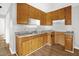 Functional kitchen features wood cabinets, double sink, and resilient flooring at 5805 Craig Rd, Durham, NC 27712