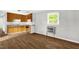 Kitchen features wood cabinets, marble look countertops, wood-look floors, and a window at 5805 Craig Rd, Durham, NC 27712