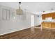 Spacious living room with wood-look flooring, neutral paint, and view to kitchen at 5805 Craig Rd, Durham, NC 27712