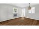 Living room with window, wood-look floors and vintage gas heater at 5805 Craig Rd, Durham, NC 27712