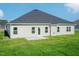 Home's backyard with a cozy patio and neatly manicured lawn at 61 Merrifield Ln, Garner, NC 27529
