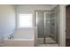 Bathroom with garden tub and separate glass-enclosed shower at 61 Merrifield Ln, Garner, NC 27529