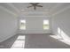 Spacious bedroom featuring tray ceilings, recessed lights, and plush carpeting at 61 Merrifield Ln, Garner, NC 27529