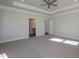 Bright bedroom boasting tray ceilings and an adjacent bathroom at 61 Merrifield Ln, Garner, NC 27529