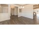 Elegant dining room featuring wainscoting, hardwood floors, and stylish chandelier at 61 Merrifield Ln, Garner, NC 27529