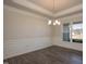 Well-lit dining area with hardwood floors, wainscoting and a modern chandelier fixture at 61 Merrifield Ln, Garner, NC 27529