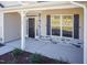 Inviting front porch with stone accents and well-kept landscaping for a welcoming entry at 61 Merrifield Ln, Garner, NC 27529