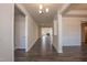 Long hallway with hardwood floors leading to various rooms, creating a sense of spaciousness at 61 Merrifield Ln, Garner, NC 27529
