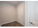 Hallway features dark wood-look floors, white walls, and a white door at 61 Merrifield Ln, Garner, NC 27529