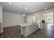 Gourmet kitchen island with granite countertops and stainless appliances open to the living area at 61 Merrifield Ln, Garner, NC 27529