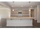 Spacious kitchen featuring a large island, stainless steel appliances, and stylish gray cabinetry at 61 Merrifield Ln, Garner, NC 27529