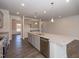 Bright kitchen features a large island with granite countertops and stainless steel appliances at 61 Merrifield Ln, Garner, NC 27529