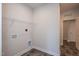 Functional laundry room with overhead shelving, modern hookups, and stylish gray tile floors at 61 Merrifield Ln, Garner, NC 27529
