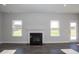 Living room with a fireplace, bright windows, and a back door leading to the outside at 61 Merrifield Ln, Garner, NC 27529