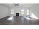 Bright and airy living room featuring wood floors, a modern ceiling fan, and a cozy fireplace at 61 Merrifield Ln, Garner, NC 27529