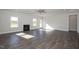 Bright living room featuring a modern fireplace, ample natural light, and beautiful wood flooring at 61 Merrifield Ln, Garner, NC 27529