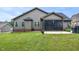 Expansive backyard features a screened porch with string lights and lush green lawn at 67 Marshlane Way, Clayton, NC 27527