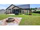 Spacious backyard with a stone fire pit, perfect for gatherings, with grill and screened porch at 67 Marshlane Way, Clayton, NC 27527