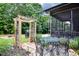 Backyard showing a patio, screened porch, garden area and wooden pergola at 67 Marshlane Way, Clayton, NC 27527