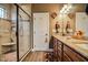 Well-lit bathroom with double vanity, granite counters, and glass shower with tile surround at 67 Marshlane Way, Clayton, NC 27527