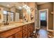Double vanity bathroom with granite countertops, wood cabinets, and a walk-in shower at 67 Marshlane Way, Clayton, NC 27527
