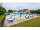 Large community pool with ample seating, umbrellas, and a clubhouse in a Gathering friendly neighborhood at 67 Marshlane Way, Clayton, NC 27527