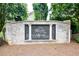 Elegant entrance sign for The Knolls at the Neuse community, surrounded by lush greenery at 67 Marshlane Way, Clayton, NC 27527