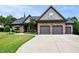 Charming home featuring a meticulously manicured lawn and a spacious three car garage at 67 Marshlane Way, Clayton, NC 27527