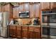 Close up of the kitchen showing stainless microwave, cooktop, ovens, and granite countertops at 67 Marshlane Way, Clayton, NC 27527
