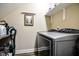 Functional laundry room featuring a washer and dryer and a shelf for storage at 67 Marshlane Way, Clayton, NC 27527