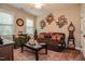 Charming living room featuring a leather sofa, decorative furniture, and carpet at 67 Marshlane Way, Clayton, NC 27527