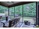 Relaxing screened-in porch offering a peaceful view of the lush backyard and mature trees at 67 Marshlane Way, Clayton, NC 27527