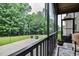A screened porch with a view of the backyard and concrete patio perfect for relaxing outdoors at 67 Marshlane Way, Clayton, NC 27527