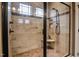 Large walk-in shower features tile surround, built-in bench, and glass door at 67 Marshlane Way, Clayton, NC 27527