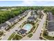 Aerial view of a neighborhood with a community pool, townhomes, and lush landscaping at 740 Treviso Ln, Apex, NC 27502