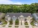 Aerial view of townhomes in a community with lush green trees and landscaping at 740 Treviso Ln, Apex, NC 27502
