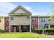 Townhome exterior with multiple windows, doors, and a well-maintained lawn at 740 Treviso Ln, Apex, NC 27502