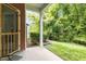 Covered back porch offers a serene view of the backyard lawn and trees at 740 Treviso Ln, Apex, NC 27502