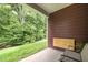 Cozy back porch with brown wood paneling and a view of lush green trees at 740 Treviso Ln, Apex, NC 27502