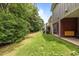 View of the backyard, showcasing the patio area and green space at 740 Treviso Ln, Apex, NC 27502