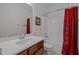 Cozy bathroom features a white vanity, toilet, and shower with floral curtains at 740 Treviso Ln, Apex, NC 27502