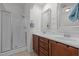 Bright bathroom featuring a walk-in shower and double sink vanity with modern fixtures at 740 Treviso Ln, Apex, NC 27502