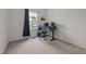 Minimalist bedroom features a work desk, computer monitors, and a view of the outdoors at 740 Treviso Ln, Apex, NC 27502