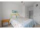 Bright bedroom with a colorful bedspread, neutral walls, and a side table with a lamp at 740 Treviso Ln, Apex, NC 27502